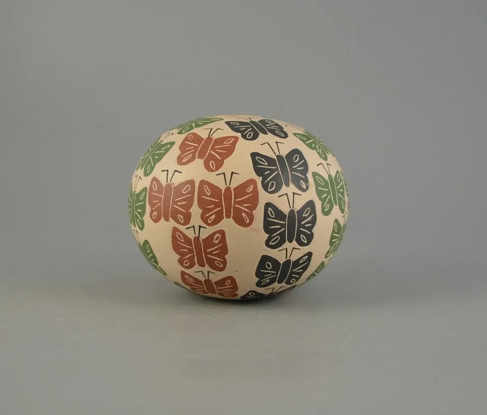 MATA ORTIZ SPHERICAL POT - COLORFUL BUTTERFLIES - ETCHED & HAND PAINTED: MATA ORTIZ SPHERICAL POT - COLORFUL BUTTERFLIES - ETCHED & HAND PAINTED This lovely butterfly pot was made by Mata Ortiz artist Raul Pedregon Bugarini. It measures 3" tall and 3 1/2" across. It is sig
