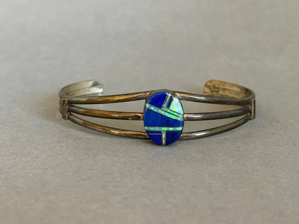 VINTAGE ZUNI STERLING SILVER WITH INLAID LAPIS AND OPAL: VINTAGE ZUNI STERLING SILVER WITH INLAID LAPIS AND OPAL Vintage Zuni Sterling Silver with Inlaid Lapis Lazuli and Opal ..5/8 " 5 1/8" Inside Around .. With a 1 1/2 " Opening ..