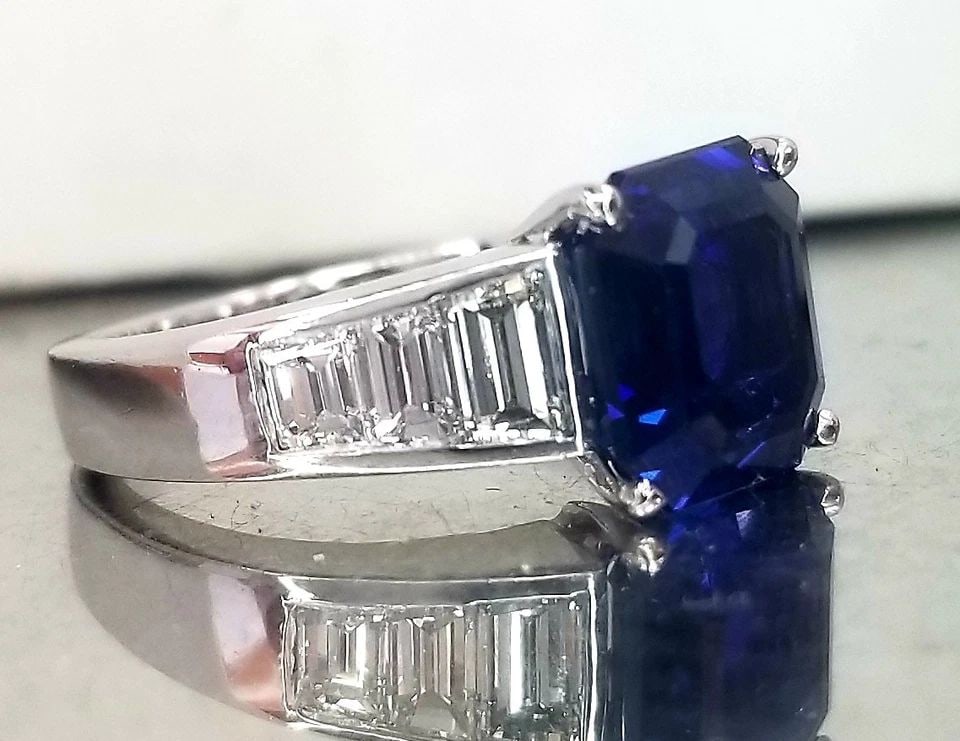 PLATINUM ENGAGEMENT RING 4.03CT. NATURAL BLUE SAPPHIRE EMERALD CUT AGL CERT: PLATINUM ENGAGEMENT RING 4.03CT. NATURAL BLUE SAPPHIRE EMERALD CUT AGL CERT 4.03 Carats AGL Certified Fine Natural Sapphire & Diamond Ring Platinum Composition: platinum Primary Stones: Natural Sapphi