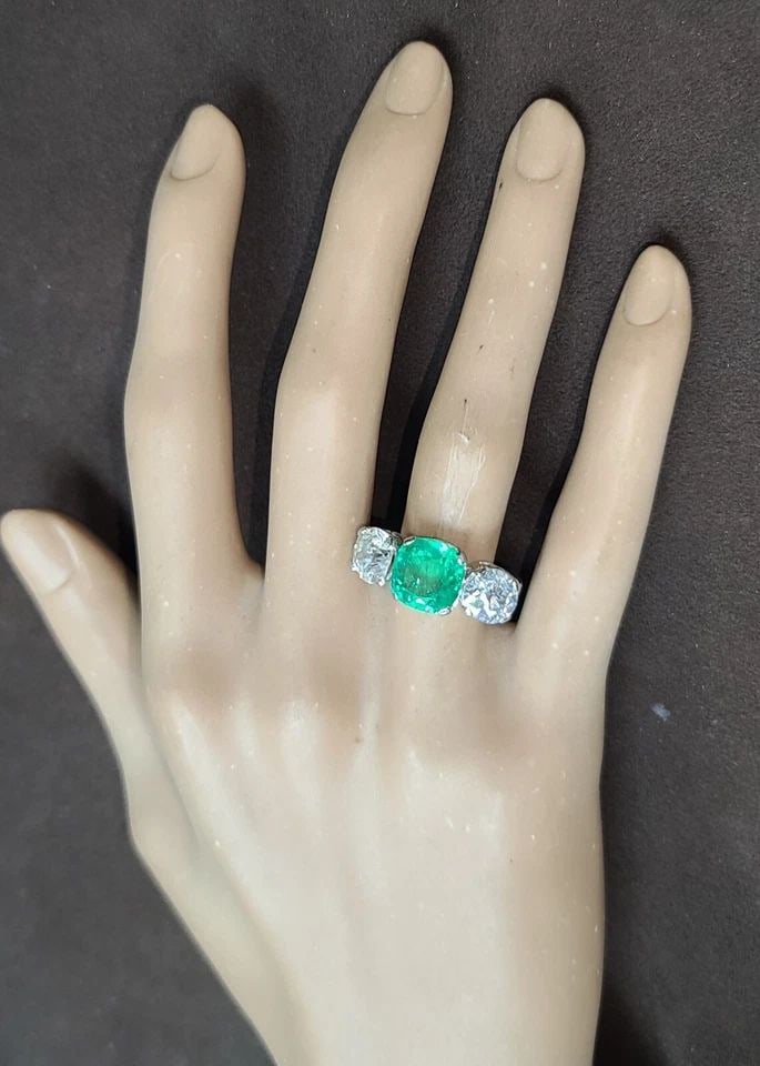 VINTAGE PLATINUM ENGAGEMENT RING 6.37CT. NATURAL COLOMBIA EMERALD OLD EURO DIA: VINTAGE PLATINUM ENGAGEMENT RING 6.37CT. NATURAL COLOMBIA EMERALD OLD EURO DIA This exquisite Filigree Platinum Engagement Ring boasts a stunning 3.42ct. natural Colombia emerald, set in a three-stone