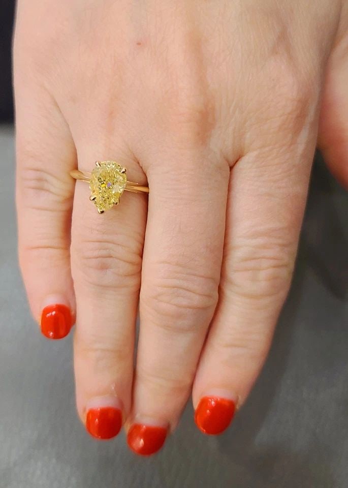 14K YELLOW GOLD ENGAGEMENT RING 3.51CT. NATURAL PEAR CUT YELLOW DIAMOND GIA CERT: 14K YELLOW GOLD ENGAGEMENT RING 3.51CT. NATURAL PEAR CUT YELLOW DIAMOND GIA CERT This exquisite 14k yellow gold engagement ring is a true masterpiece. The ring features a stunning 3.51CT natural pear 