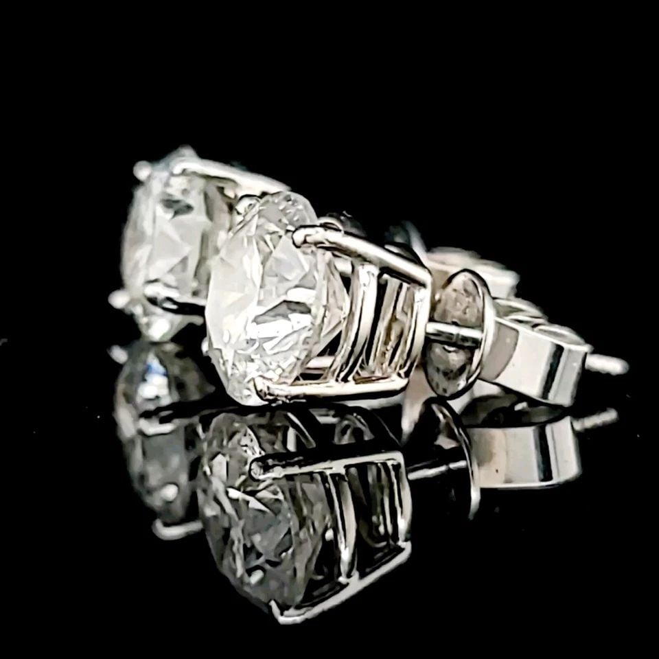 VINTAGE 14K WHITE GOLD STUDS EARRINGS 5.18CT. NATURAL ROUND DIAMOND: VINTAGE 14K WHITE GOLD STUDS EARRINGS 5.18CT. NATURAL ROUND DIAMOND Elevate your jewelry collection with these vintage 14K white gold stud earrings, featuring 5.18ct natural round diamonds. These earr