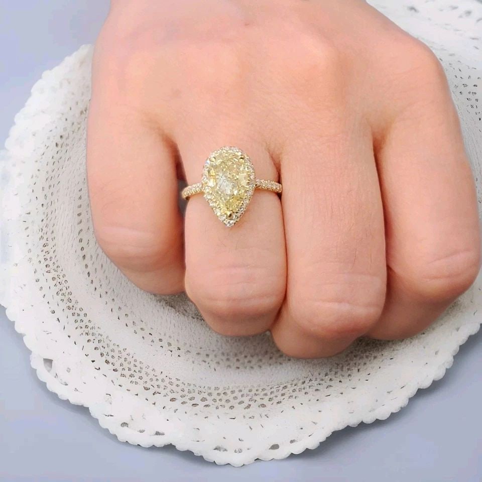 14K YELLOW GOLD ENGAGEMENT RING 2.50CT. NATURAL PEAR CUT YELLOW DIAMOND GIA CERT: 14K YELLOW GOLD ENGAGEMENT RING 2.50CT. NATURAL PEAR CUT YELLOW DIAMOND GIA CERT This stunning 14k yellow gold engagement ring features a 2.50 carat natural pear cut yellow diamond, graded excellent b