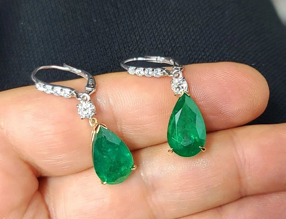 14K YELLOW GOLD NATURAL GREEN EMERALD DROP EARRINGS 11.92CT PEAR SHAPE DIAMOND: 14K TWO-TONE GOLD GEM NATURAL GREEN EMERALD DROP EARRINGS 11.92CT PEAR GIA CERT These 14k two-tone gold drop earrings feature natural green emerald stones in pear shape, totaling 11.92CT. The earrings