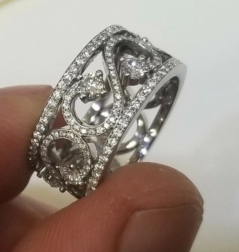 1.35CT. TIFFANY & CO PLATINUM ENCHANT SCROLL BAND RING SIZE : 6 SZ: 1.35CT. TIFFANY & CO PLATINUM ENCHANT SCROLL BAND RING SIZE : 6 SZ DESCRIPTION Tiffany Enchant Scroll Band Ring The scrolled iron gates of opulent estates and secret gardens inspired this ornate colle