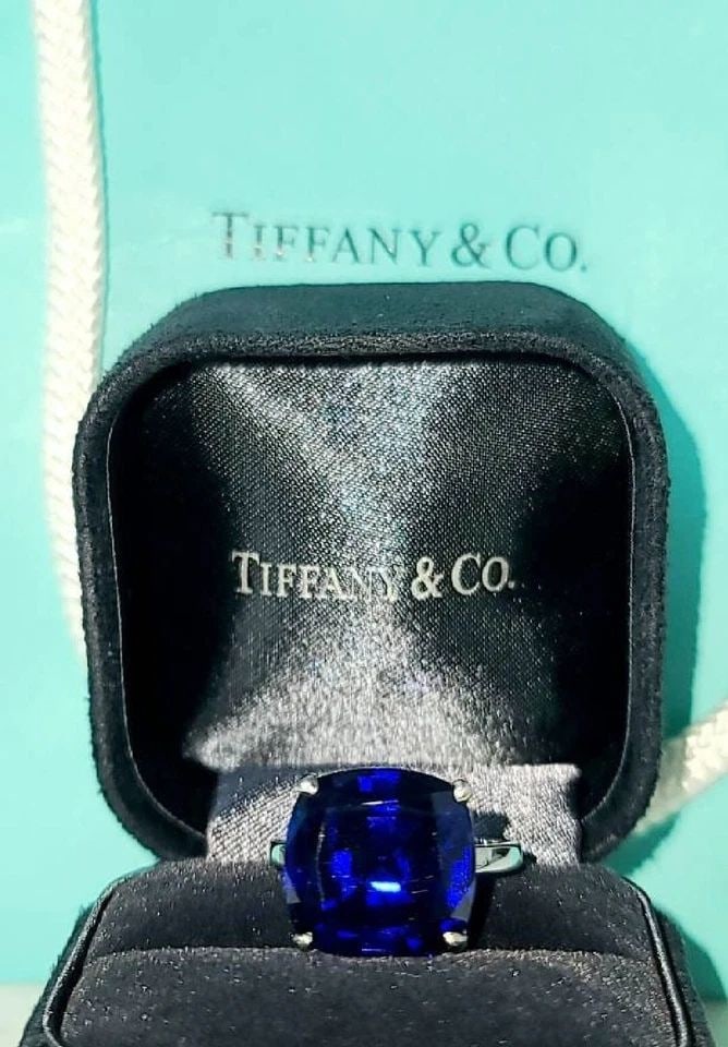 TIFFANY & CO 18K WHITE GOLD ENGAGEMENT RING 14.25CT. BLUE SAPPHIRE CUSHION CUT: TIFFANY & CO 18K WHITE GOLD ENGAGEMENT RING 14.25CT. BLUE SAPPHIRE CUSHION CUT This stunning ring from Tiffany & Co. is the perfect choice for any special occasion, whether it's for an engagement, bir