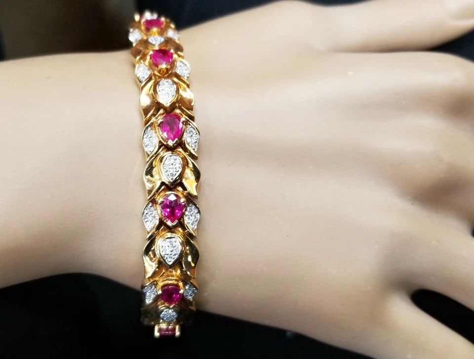 18K YELLOW GOLD NATURAL PEAR RUBY & DIAMOND TENNIS BRACELET 6.28CTW: 18K YELLOW GOLD BRACELET NATURAL DIAMOND RUBY 6.28CT. PEAR SHAPE GORGEOUS 18K YELLOW GOLD DIAMOND RUBY BRACELET SET WITH NATURAL PEAR RUBY TOTAL WEIGHT 5.21CTS SET NATURAL DIAMOND 1.07CT TW. SI1-H THI