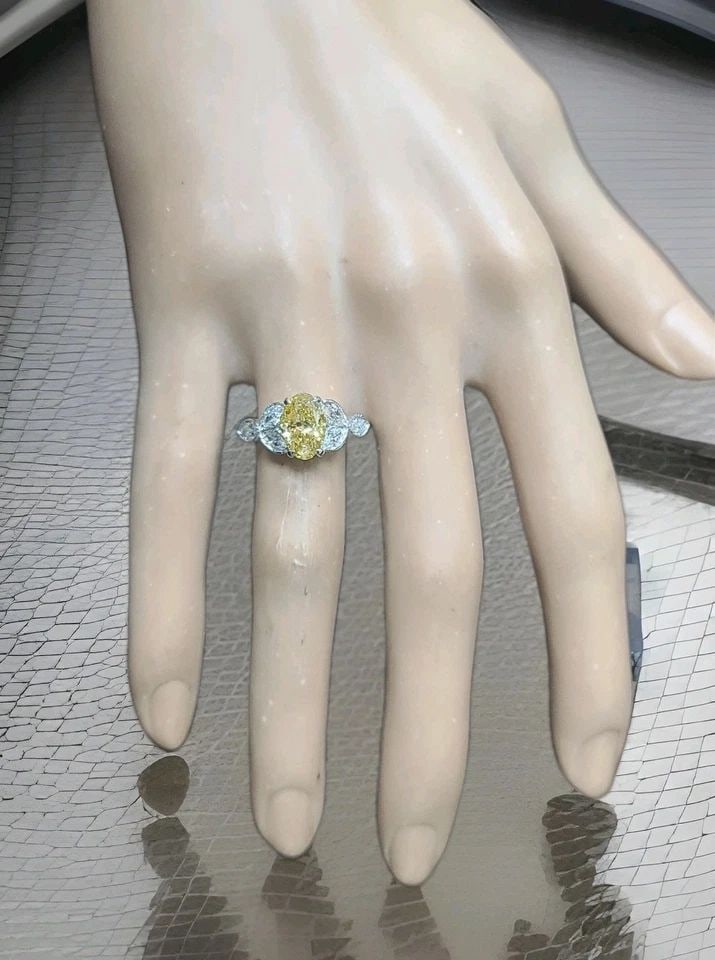 VINTAGE PLATINUM ENGAGEMENT RING 1.52CT.NATURAL YELLOW DIAMOND OVAL SHAPE: Vintage Platinum Engagement Ring 1.52CT.Natural Yellow Diamond Oval Shape This stunning vintage engagement ring is crafted in platinum and features a natural fancy oval yellow diamond weighing approxi