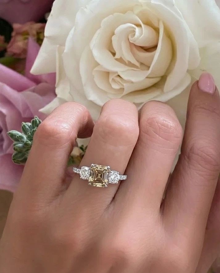 14K WHITE GOLD VINTAGE ENGAGEMENT RING 2.06CT. CHAMPAGNE DIAMOND ASSCHER CUT: 14K WHITE GOLD VINTAGE ENGAGEMENT RING 2.06CT. CHAMPAGNE DIAMOND ASSCHER CUT This beautiful vintage engagement ring is expertly crafted in solid 14K white gold and showcases a striking 2.06ct natural 