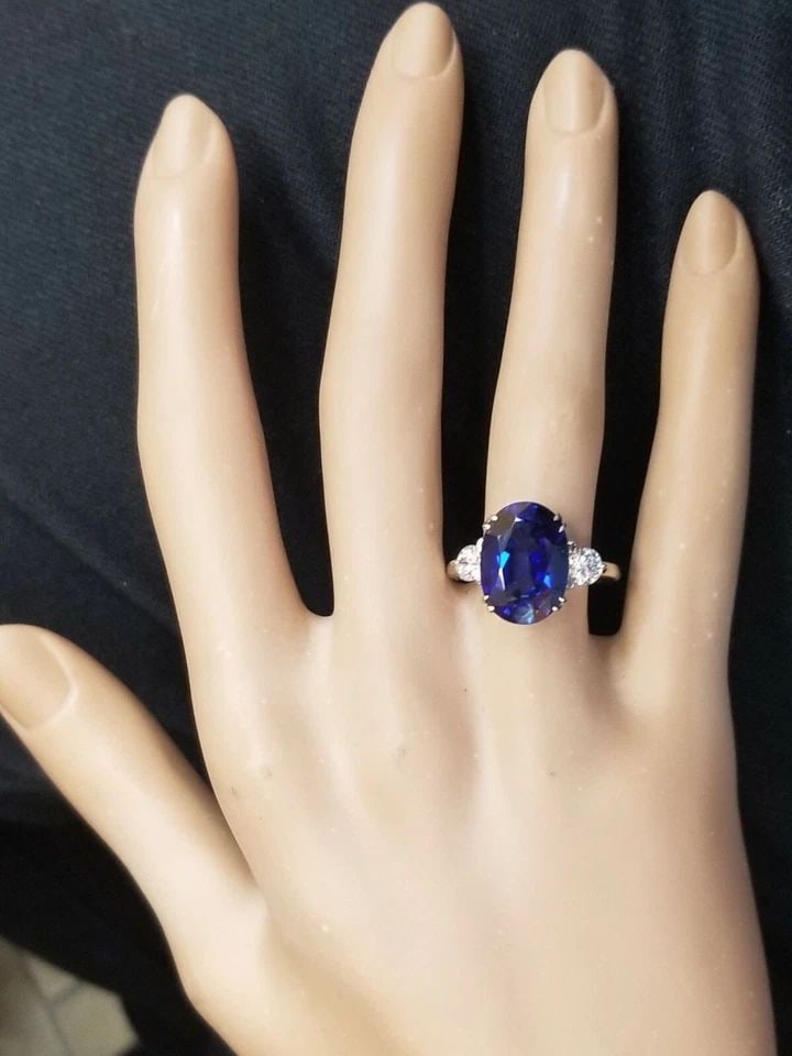 VINTAGE 14K WHITE GOLD ENGAGEMENT RING 7.05CT. GEM BLUE SAPPHIRE OVAL SHAPE: VINTAGE 14K WHITE GOLD ENGAGEMENT RING 7.05CT. GEM BLUE SAPPHIRE OVAL SHAPE GORGEOUS 14k white gold blue sapphire in an oval shape Center lab-grown sapphire weight 7.05ct. size 14x10mm very nice rich 