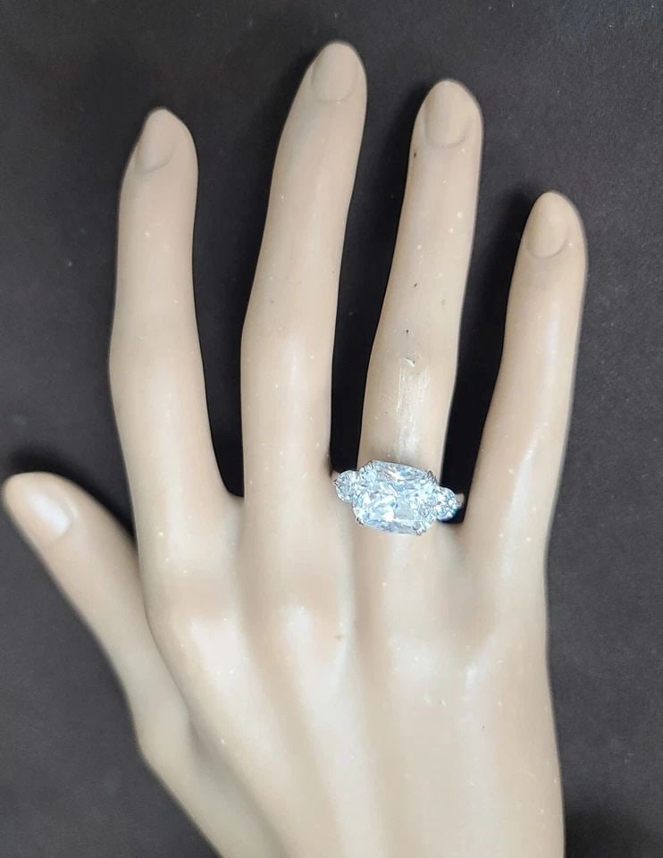 14K WHITE GOLD ENGAGEMENT RING 6.18CT LAB GROWN SIMULATE DIAMOND CUSHION SHAPE: 14K WHITE GOLD ENGAGEMENT RING 6.18CT LAB GROWN SIMULATE DIAMOND CUSHION SHAPE This stunning engagement band is crafted from 14k white gold and features a lab-grown simulated diamond in a cushion shap
