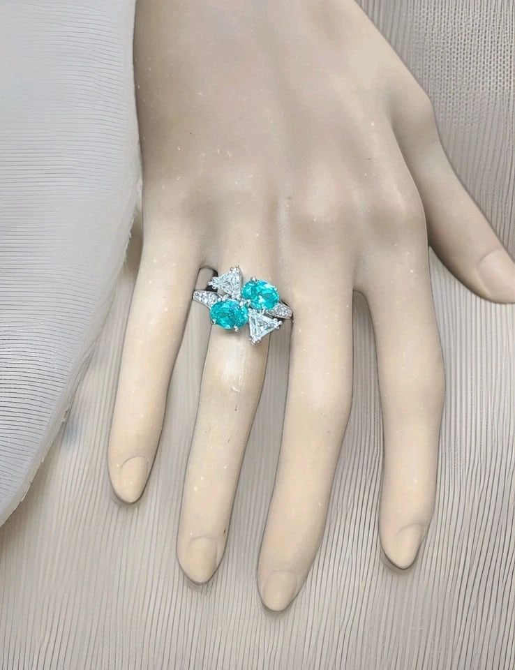 PLATINUM VINTAGE NATURAL DIAMOND RING 3.94CT OVAL NEON BLUE TOURMALINE: Platinum Vintage Natural Diamond Ring 3.94ct Oval Neon Blue Tourmaline This striking vintage cocktail ring is crafted in platinum and showcases a matched pair of lab-grown oval neon blue tourmalines t