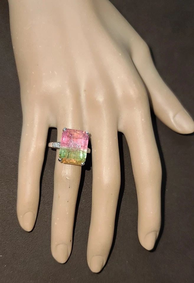 VINTAGE 14K WHITE GOLD ENGAGEMENT RING 15.67CT.NATURAL BIO TOURMALINE: VINTAGE 14K WHITE GOLD ENGAGEMENT RING15.67CT.NATURAL BIO TOURMALINE EMERALD CUT This vintage 14k white gold engagement ring features a stunning 15.67CT natural bio tourmaline gemstone with an emerald