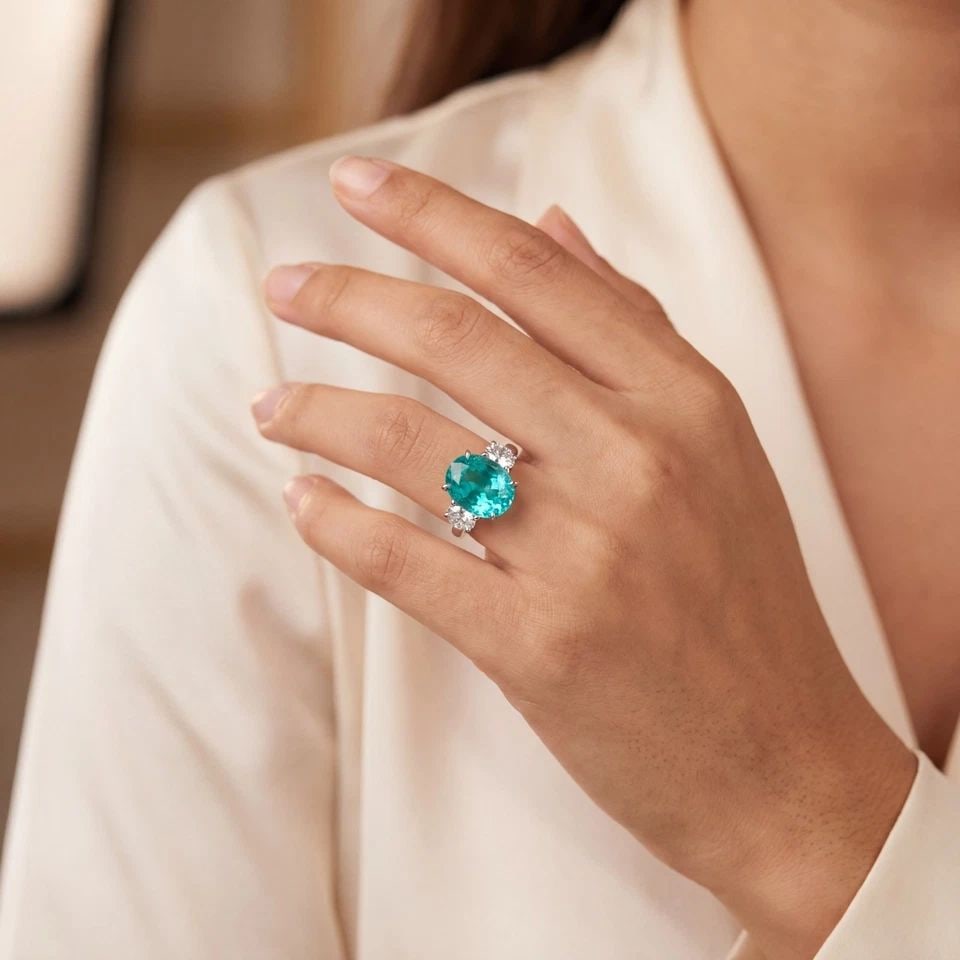VINTAGE 14K WHITE GOLD ENGAGEMENT RING 7.48CT. NEON BLUE TOURMALINE OVAL SHAPE: VINTAGE 14K WHITE GOLD ENGAGEMENT RING 7.48CT. NEON BLUE TOURMALINE OVAL SHAPE This gorgeous vintage 14K white gold engagement ring features a stunning lab-grown Paraíba-color tourmaline in an elegan