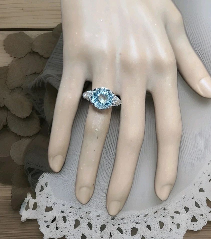 VINTAGE 14K WHITE GOLD ENGAGEMENT RING 7.61CT. NATURAL SKY BLUE AQUAMARINE ROUND: VINTAGE 14K WHITE GOLD ENGAGEMENT RING 7.61CT. NATURAL SKY BLUE AQUAMARINE ROUND This vintage 14K white gold engagement ring features a stunning natural sky blue aquamarine round stone with a total ca