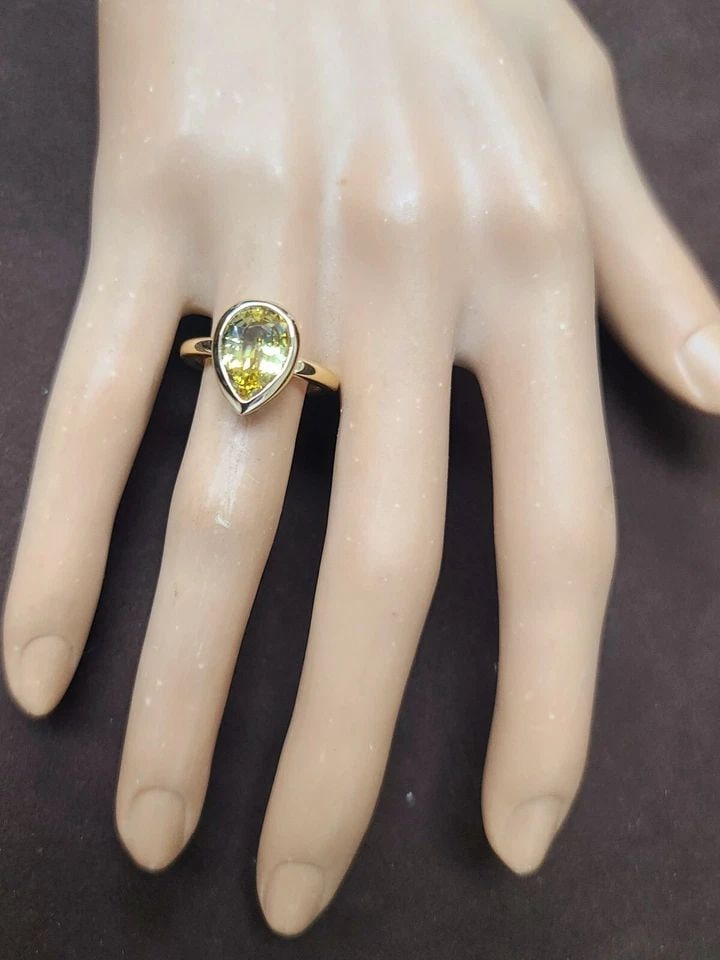 VINTAGE 14K YELLOW GOLD ENGAGEMENT RING 3.54 CT. NATURAL YELLOW SAPPHIRE: VINTAGE 14K YELLOW GOLD ENGAGEMENT RING 3.54 CT. NATURAL YELLOW SAPPHIRE This stunning vintage ring is crafted from 14k yellow gold and features a 3.54CT natural yellow sapphire in pear cut and, a gor
