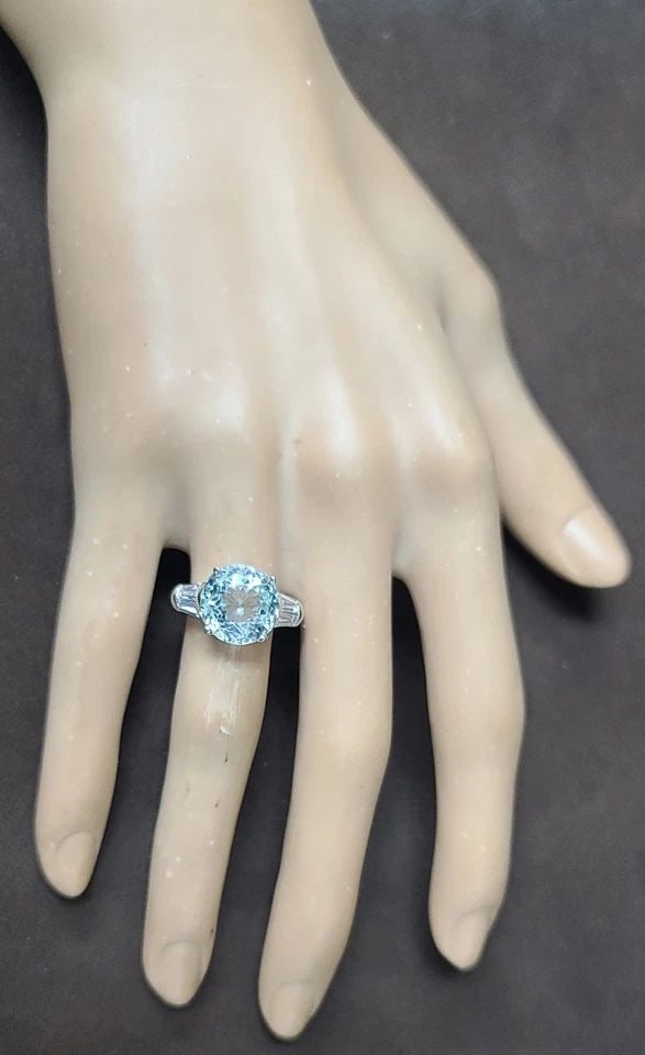 VINTAGE PLATINUM ENGAGEMENT RING 6.67CT. NATURAL SKY BLUE AQUAMARINE ROUND CUT: VINTAGE PLATINUM ENGAGEMENT RING 6.67CT. NATURAL SKY BLUE AQUAMARINE ROUND CUT The Vintage Platinum Engagement Ring features a stunning 6.67ct natural sky blue aquamarine with a round cut. This unique