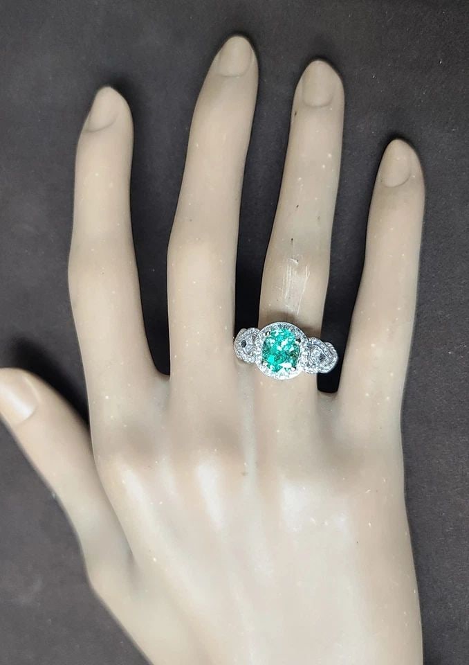 18K WHITE GOLD ENGAGEMENT RING 1.62CT. NATURAL GREEN COLOMBIA EMERALD OVAL SHAPE: 18K WHITE GOLD ENGAGEMENT RING 1.62CT. NATURAL GREEN COLOMBIA EMERALD OVAL SHAPE This 18K White Gold Engagement Ring features a stunning 1.62CT Natural Green Colombia Emerald in an oval shape. Surroun