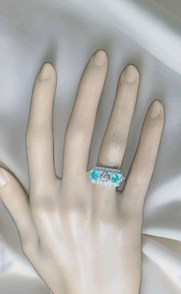 VINTAGE PLATINUM RING 1.48CT.NATURAL OLD CUT CHAMPAGNE DIAMOND BLUE TOURMALINE: VINTAGE PLATINUM RING 1.48CT.NATURAL OLD CUT CHAMPAGNE DIAMOND BLUE TOURMALINE This vintage platinum ring features natural old cut champagne diamond with side blue tourmaline gemstone. The three-stone