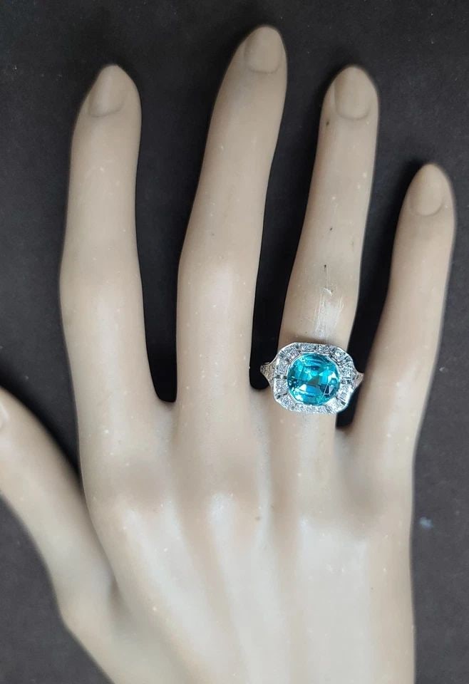 VINTAGE PLATINUM FILIGREE RING 3.34CT.LAB-GROWN PARAIBA TOURMALINE ROUND SHAPE: VINTAGE PLATINUM FILIGREE RING 3.34CT.LAB-GROWN PARAIBA TOURMALINE ROUND SHAPE This Vintage Platinum Filigree ring features a 3.34CT lab-grown Paraiba Tourmaline in a round shape, surrounded by diamon