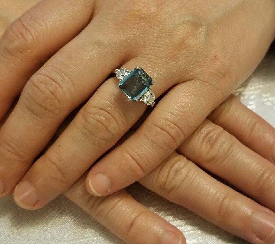 VINTAGE PLATINUM ENGAGEMENT RING 2.87CT. NATURAL BLUE AQUAMARINE EMERALD SHAPE: VINTAGE PLATINUM ENGAGEMENT RING 2.87CT. NATURAL BLUE AQUAMARINE EMERALD SHAPE This stunning vintage platinum ring features a 2.87ct natural blue aquamarine with an emerald shape. The ring is adorned 