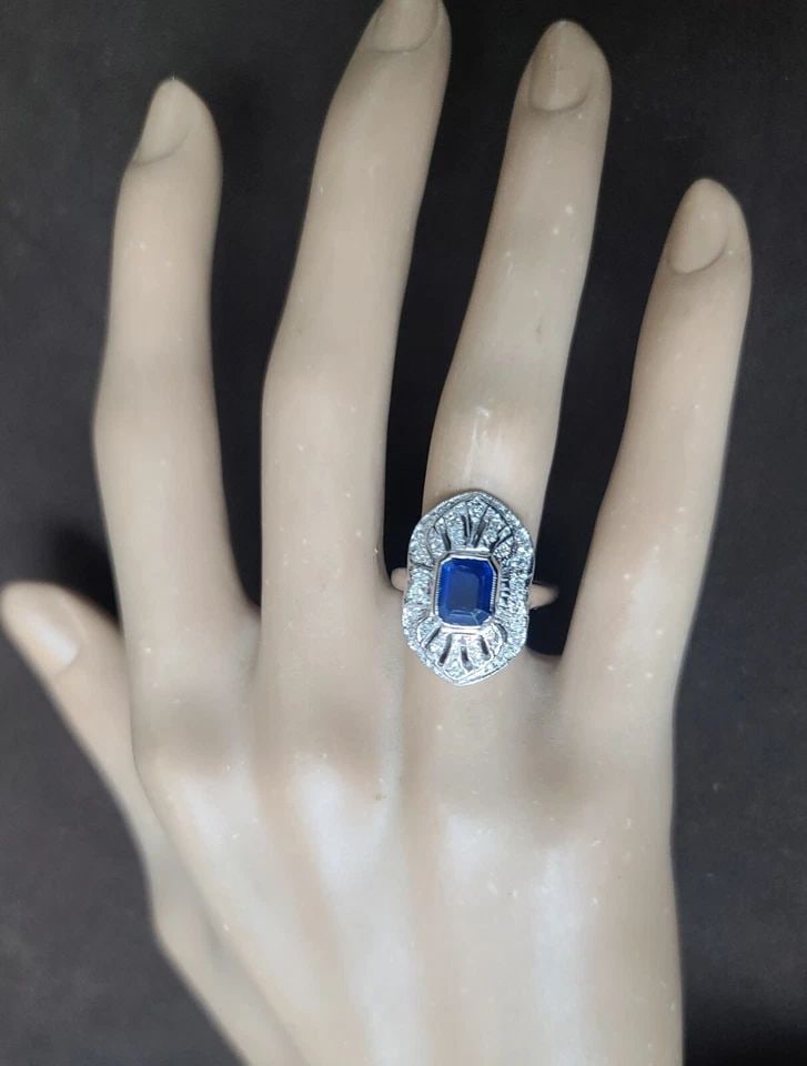 VINTAGE 14K WHITE GOLD EMERALD CUT NATURAL BLUE SAPPHIRE ENGAGEMENT RING 1.57CT.: VINTAGE 14K WHITE GOLD RING 1.57CT. NATURAL BLUE SAPPHIRE EMERALD CUT CIRC 1950' This beautiful vintage ring is crafted from 14k white gold and features a stunning 1.57CT natural blue sapphire with an
