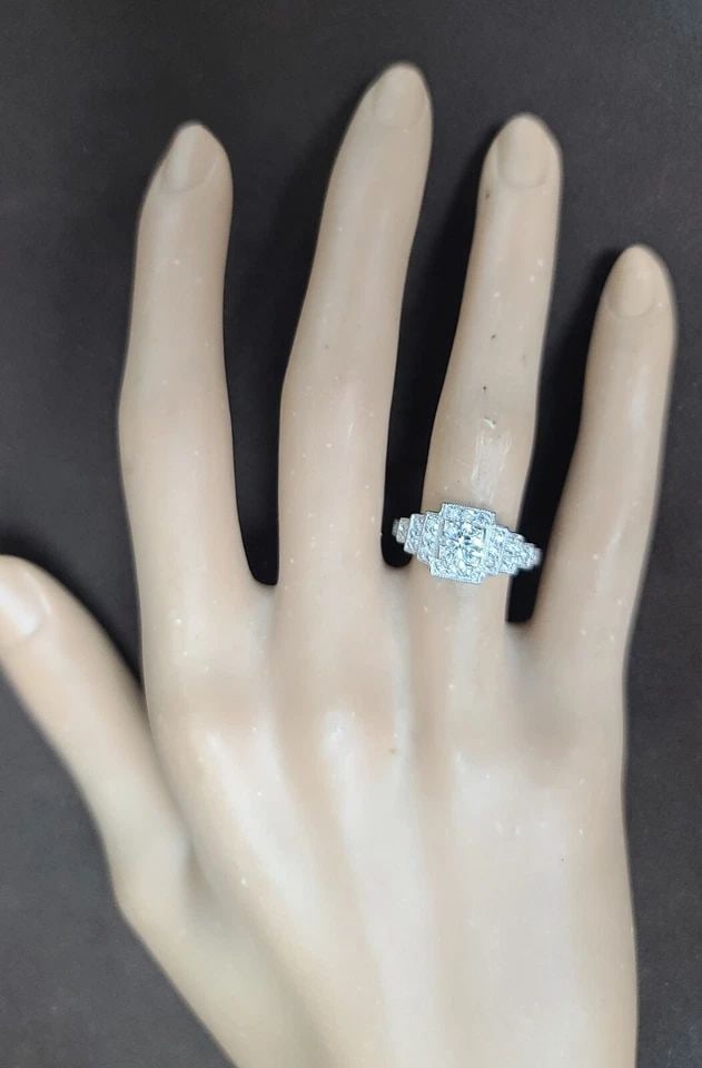 PLATINUM VINTAGE FILIGREE ENGAGEMENT RING 0.94CT. NATURAL ROUND DIAMOND: PLATINUM VINTAGE FILIGREE ENGAGEMENT RING 0.94CT. NATURAL ROUND DIAMOND This stunning vintage engagement band is a true beauty. Made of platinum, it features a round, natural diamond in a solitaire st