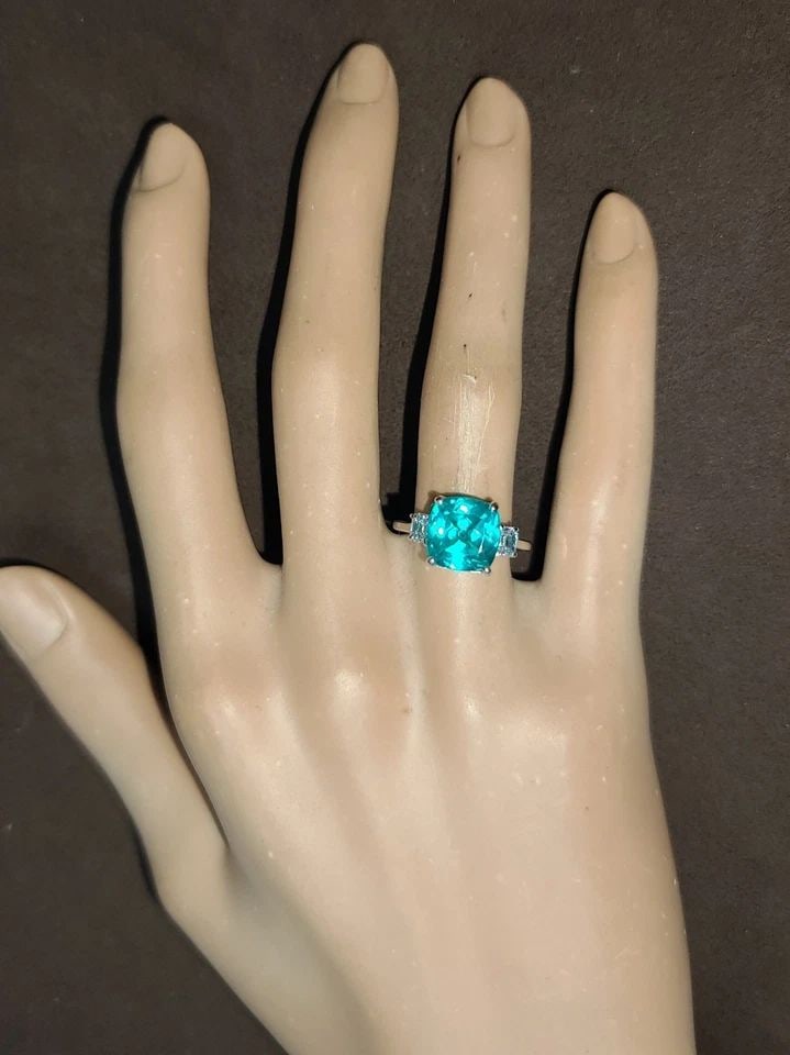 14K WHITE GOLD ENGAGEMENT RING 4.75CT. LAB-GROWN PARAIBA TOURMALINE CUSHION CUT: This stunning 14k white gold ring is the perfect choice for any special occasion, from engagements to birthdays. The ring features a 4.75CT blue Caribbean tourmaline gemstone, lab-grown and cushion cu