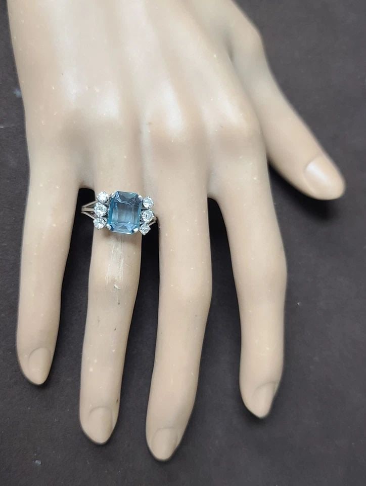 VINTAGE 18K WHITE GOLD ENGAGEMENT RING 2.02CT. NATURAL AQUAMARINE EMERALD SHAPE: VINTAGE 18K WHITE GOLD ENGAGEMENT RING 2.02CT. NATURAL AQUAMARINE EMERALD SHAPE This vintage 18k white gold engagement ring is a true gem, featuring a stunning 2.02ct natural aquamarine gemstone in an