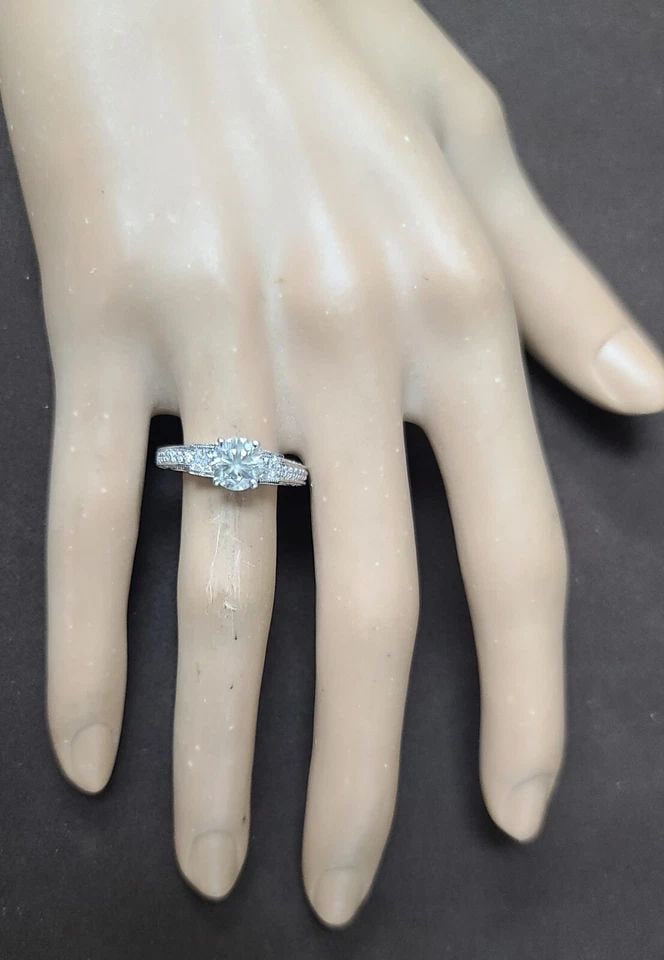 VINTAGE 18K WHITE GOLD ENGAGEMENT RING 1.20CT. NATURAL ROUND LIGHT GRAY DIAMOND: VINTAGE 18K WHITE GOLD ENGAGEMENT RING 1.20CT. NATURAL ROUND LIGHT GRAY DIAMOND This vintage 18k white gold engagement ring is a stunning piece that will make any occasion special. The ring features a