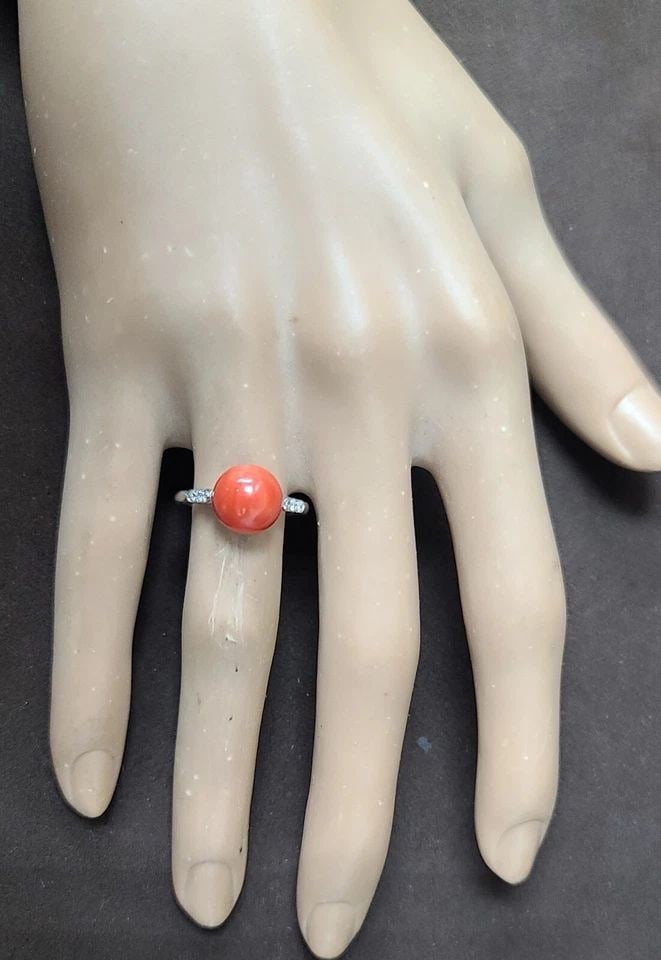 FILIGREE ART DECO VINTAGE PLATINUM ENGAGEMENT RING ROUND NATURAL RED CORAL: FILIGREE ART DECO VINTAGE PLATINUM ENGAGEMENT RING ROUND NATURAL RED CORAL This vintage platinum engagement ring showcases a beautiful round natural red coral stone. The cocktail-style ring is adorned