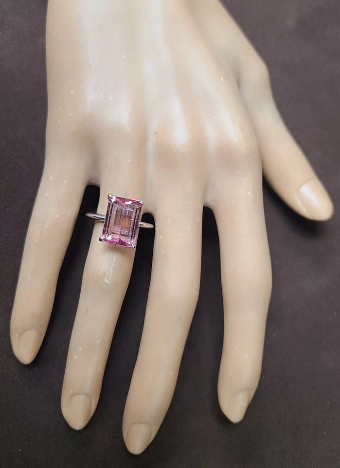 VINTAGE 14K WHITE GOLD ENGAGEMENT RING 5.27CT. NATURAL PINK TOURMALINE: VINTAGE 14K WHITE GOLD ENGAGEMENT RING 5.27CT. NATURAL PINK TOURMALINE This stunning 14k white gold ring features a breathtaking 5.27ct natural pink tourmaline in an emerald cut. The ring is perfect f