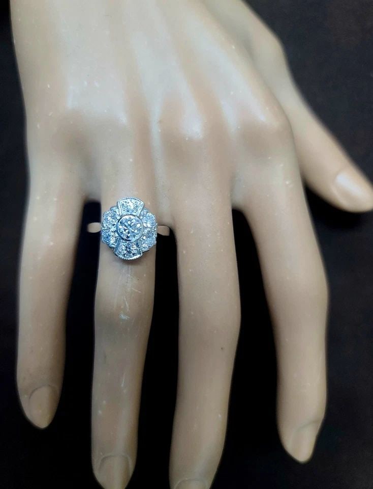 PLATINUM VINTAGE ENGAGEMENT RING 1.25CT. LAB-GROWN ROUND DIAMONDS: PLATINUM VINTAGE ENGAGEMENT RING 1.25CT. LAB-GROWN ROUND DIAMONDS This Platinum Vintage Engagement Ring features 1.25ct of lab-grown round diamonds, with a total of 7 diamonds in the setting. The ring