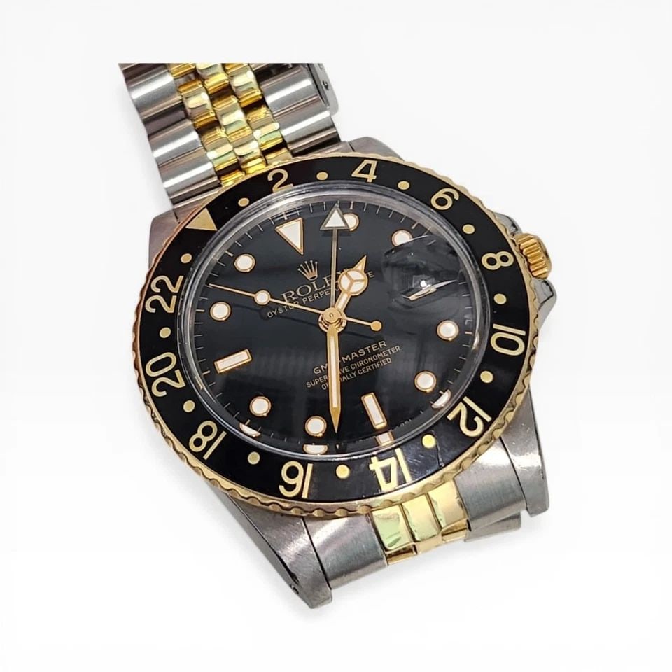 W/BOX ROLEX GMT MASTER 40 MM TWO TONE BLACK AUTOMATIC WATCH 16753 CIRCA 1979: W/BOX ROLEX GMT MASTER 40 MM TWO TONE BLACK AUTOMATIC WATCH Manufacturer Rolex Category GMT Master Subcategory Plastic Crystal Reference Number 16753 Band Steel ,Yellow Gold Band Color Yellow Gold & S
