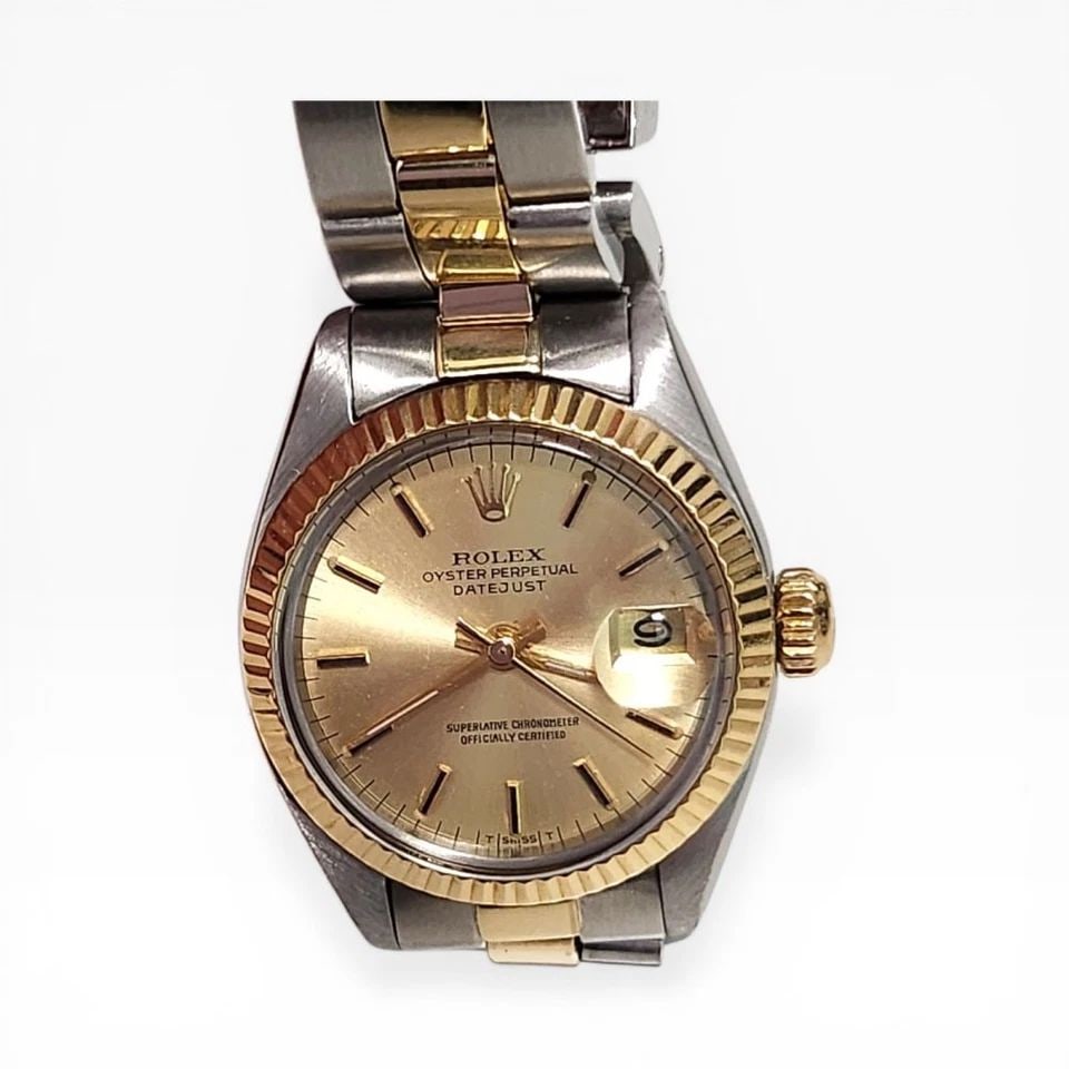 ROLEX LADIES DATEJUST 26 MM TWO TONE CHAMPAGNE OYSTER WATCH 6916 CIRCA 1978: ROLEX LADIES DATEJUST 26 MM TWO TONE CHAMPAGNE OYSTER WATCH Manufacturer Rolex Category Ladies Datejust Reference Number 6916 Band Steel ,Yellow Gold Band Color Yellow Gold & Stainless Steel Band Type