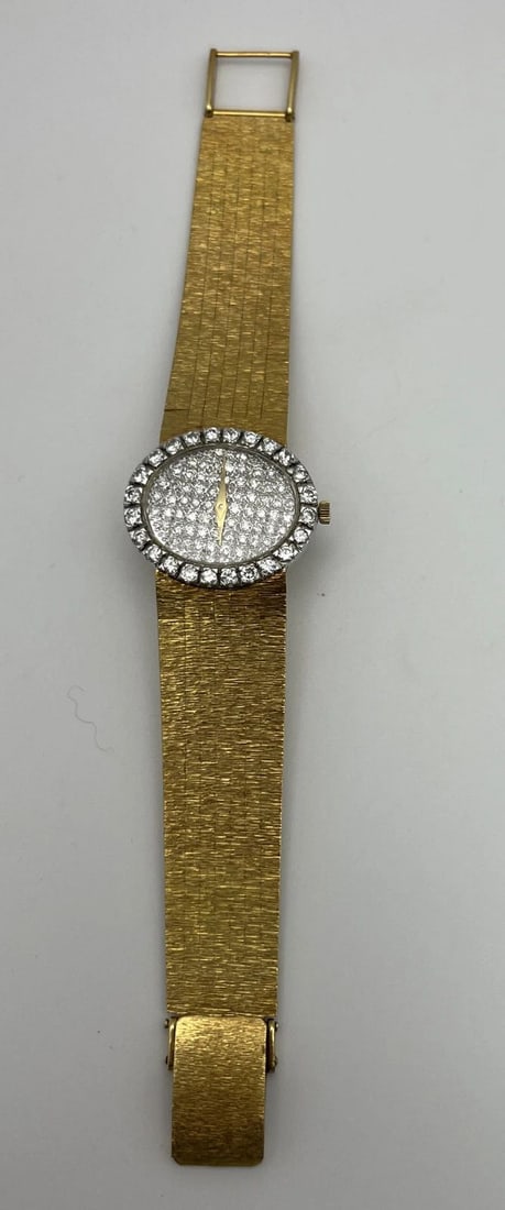 BUECHE GIROD 18K GOLD WATCH WITH DIAMOND BEZEL AND DIAMOND DIAL: BUECHE GIROD 18K GOLD WATCH WITH DIAMOND BEZEL AND DIAMOND DIAL BUECHE GIROD 18K GOLD WATCH WITH DIAMOND BEZEL AND DIAMOND DIAL 18K yellow gold wristwatch centered around a pave set diamond dial. 