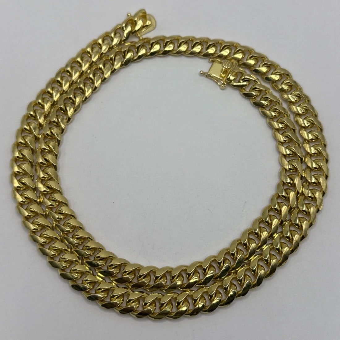 STERLING SILVER GOLD COLOR NECKLACE 24" CUBAN LINK: STERLING SILVER GOLD COLOR NECKLACE 24" CUBAN LINK STERLING SILVER GOLD COLOR NECKLACE 24" CUBAN LINK Elevate your accessory game with this sophisticated Sterling Silver Gold Color Necklace.