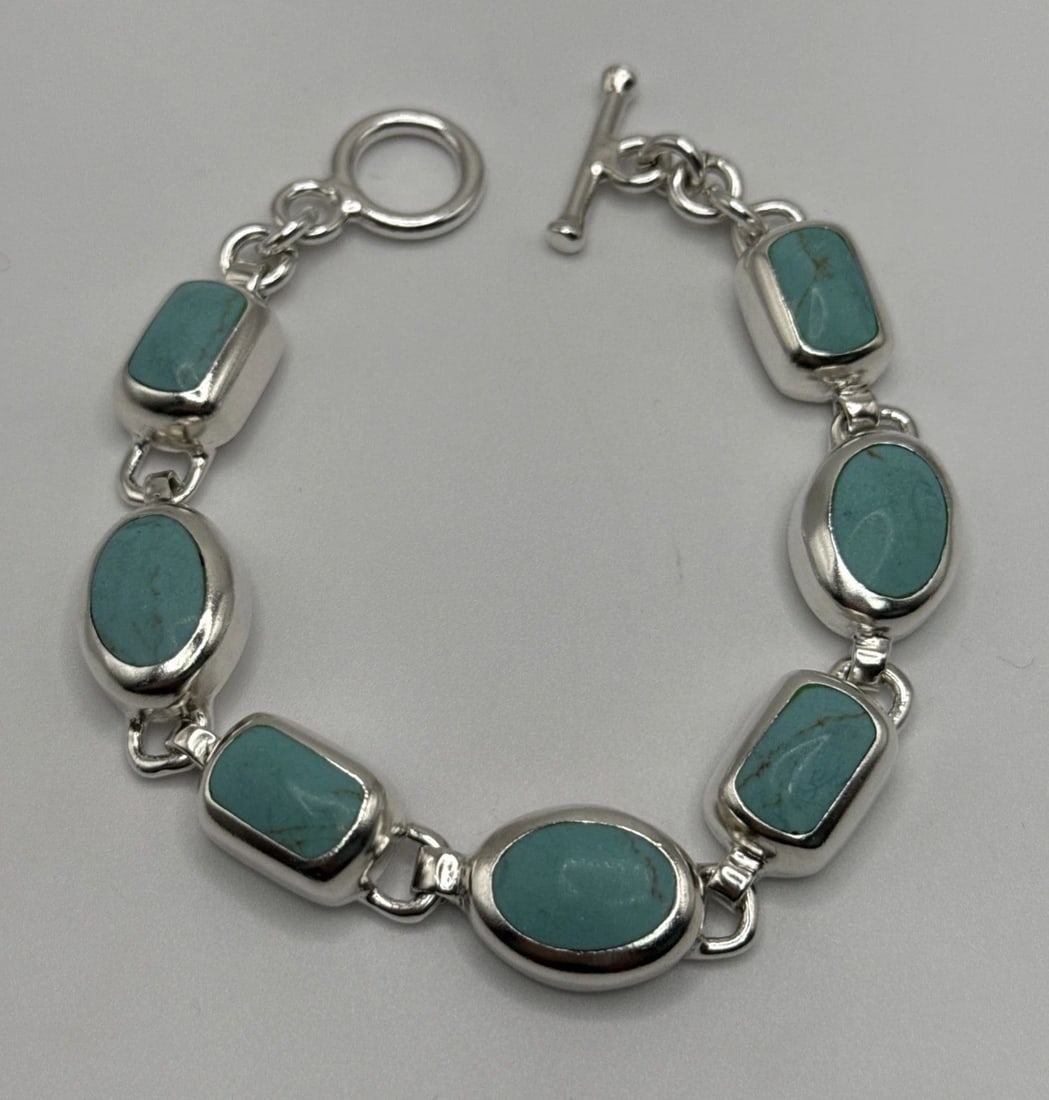 7.5" STERLING SILVER & TURQUOISE BRACELET 36.5 GRAMS: 7.5" STERLING SILVER & TURQUOISE BRACELET 36.5 GRAMS This 7.5" Sterling Silver & Turquoise Bracelet is a statement piece of Mexican jewelry, weighing 36.5 grams. The bracelet features a beautiful blue