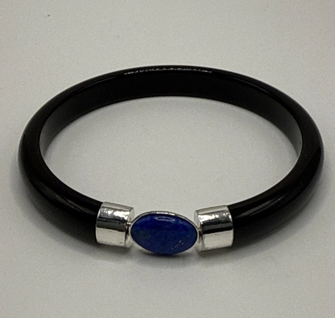 SOLID BLACK ONYX BANGLE WITH STERLING SILVER & LAPIS STONE: SOLID BLACK ONYX BANGLE WITH STERLING SILVER & LAPIS STONE This Solid Black Onyx Bangle with Sterling Silver and Lapis Stone is a vintage and antique jewelry piece that exudes elegance and sophisticat