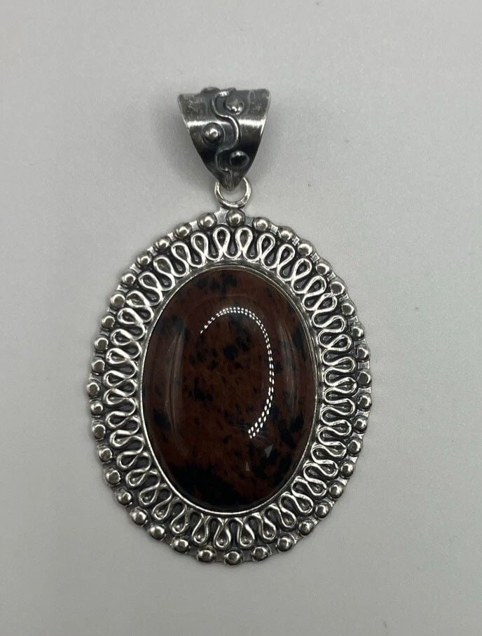 STERLING SILVER MEXICO COFFEE OBSIDIAN ORNATE PENDANT 37.7 GRAMS: STERLING SILVER MEXICO COFFEE OBSIDIAN ORNATE PENDANT 37.7 GRAMS STERLING SILVER MEXICO COFFEE OBSIDIAN ORNATE PENDANT 37.7 GRAMS This stunning pendant is crafted from 925 sterling silver and features