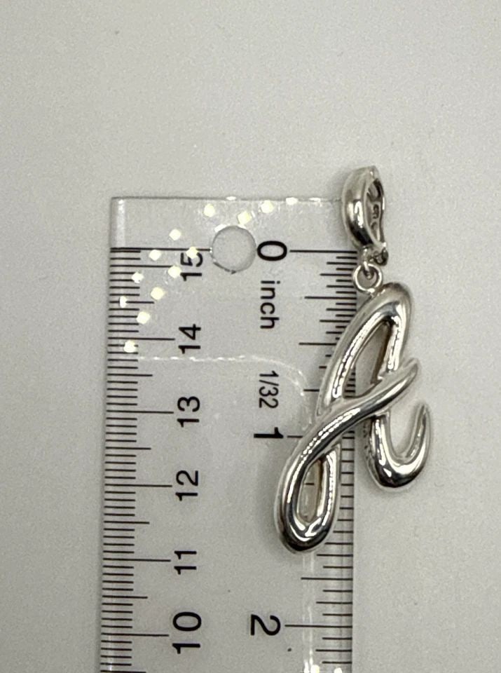 STERLING SILVER A CHARM 4.6 GRAMS: STERLING SILVER A CHARM 4.6 GRAMS The Sterling Silver A Charm is a beautifully crafted piece of fine jewelry made of high-quality 925 sterling silver. With a weight of 4.6 grams, this charm is perfect