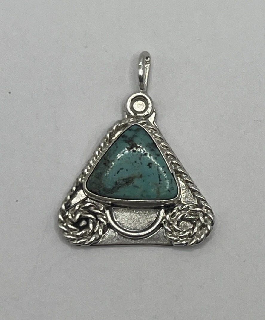 STERLING SILVER & TURQUOISE TRIANGLE PENDANT 4.7 GRAMS: STERLING SILVER & TURQUOISE TRIANGLE PENDANT 4.7 GRAMS STERLING SILVER & TURQUOISE TRIANGLE PENDANT 4.7 GRAMS This Sterling Silver & Turquoise Triangle Pendant weighs 4.7 grams and features a Native A