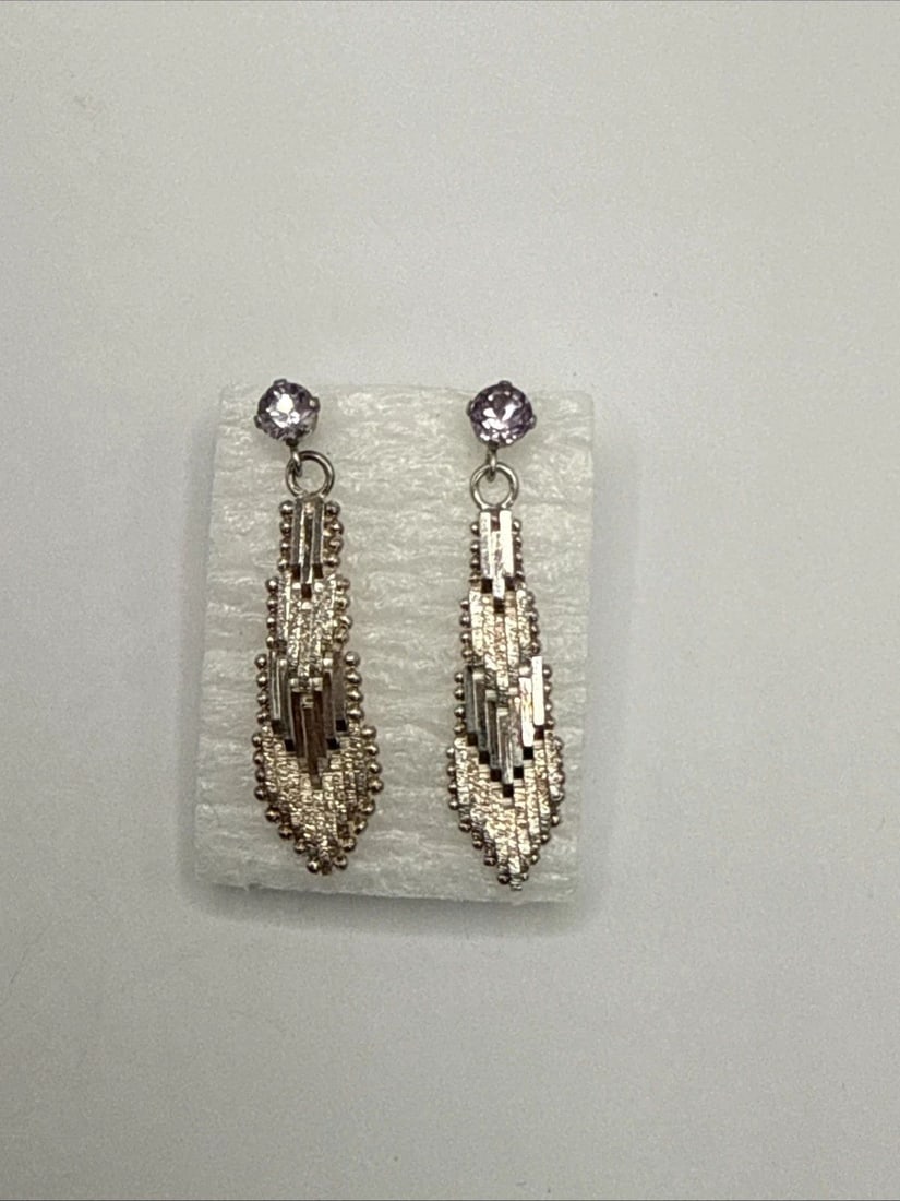 STERLING SILVER MESH EARRINGS WITH LIGHT PURPLE STONE: STERLING SILVER MESH EARRINGS WITH LIGHT PURPLE STONE These Sterling Silver Mesh Earrings feature a delicate dangle/drop style, perfect for adding a touch of elegance to any outfit. The earrings are m