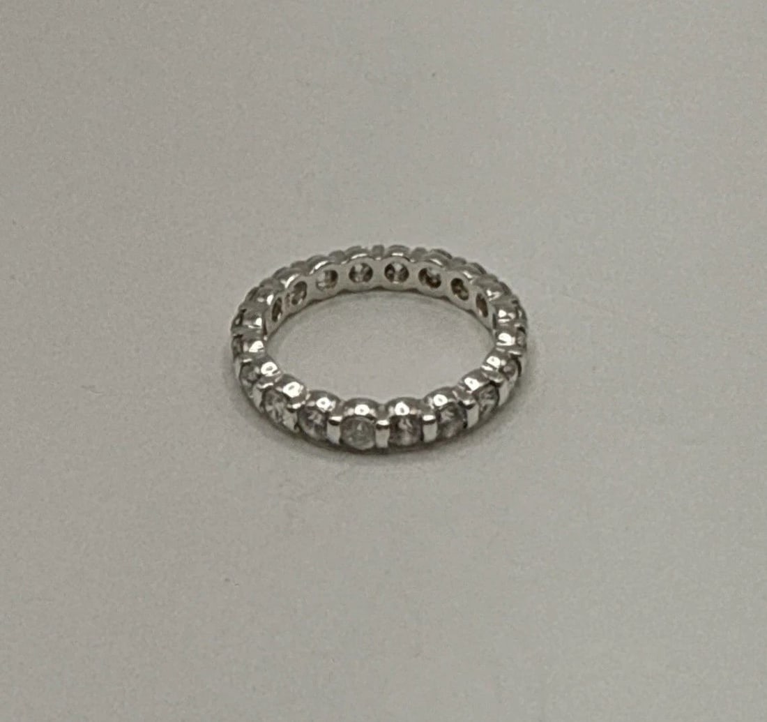STERLING SILVER AND COLORLESS STONE ETERNITY BAND SIZE 7 (1 of 2)
