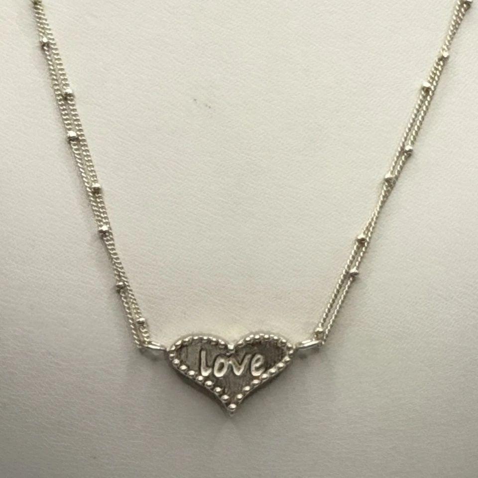 SOPHIA & CHLOE ADJUSTABLE INSCRIBED HEART NECKLACE: SOPHIA & CHLOE ADJUSTABLE INSCRIBED HEART NECKLACE SOPHIA & CHLOE ADJUSTABLE INSCRIBED HEART NECKLACE Crafted by Sophia & Chloe, this charming necklace features a unique heart pendant with beaded