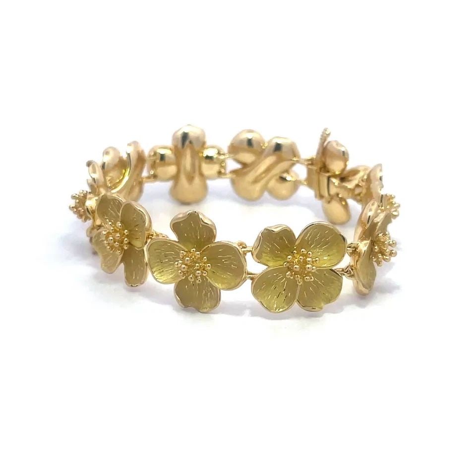 TIFFANY & CO. DOGWOOD GOLD BRACELET 18K YELLOW FLOWER LINK STYLE: TIFFANY & CO. DOGWOOD GOLD BRACELET 18K YELLOW FLOWER LINK STYLE This charming authentic bracelet is by Tiffany & Co. from the Dogwood Collection. The bracelet is a stunning piece of fine jewelry feat