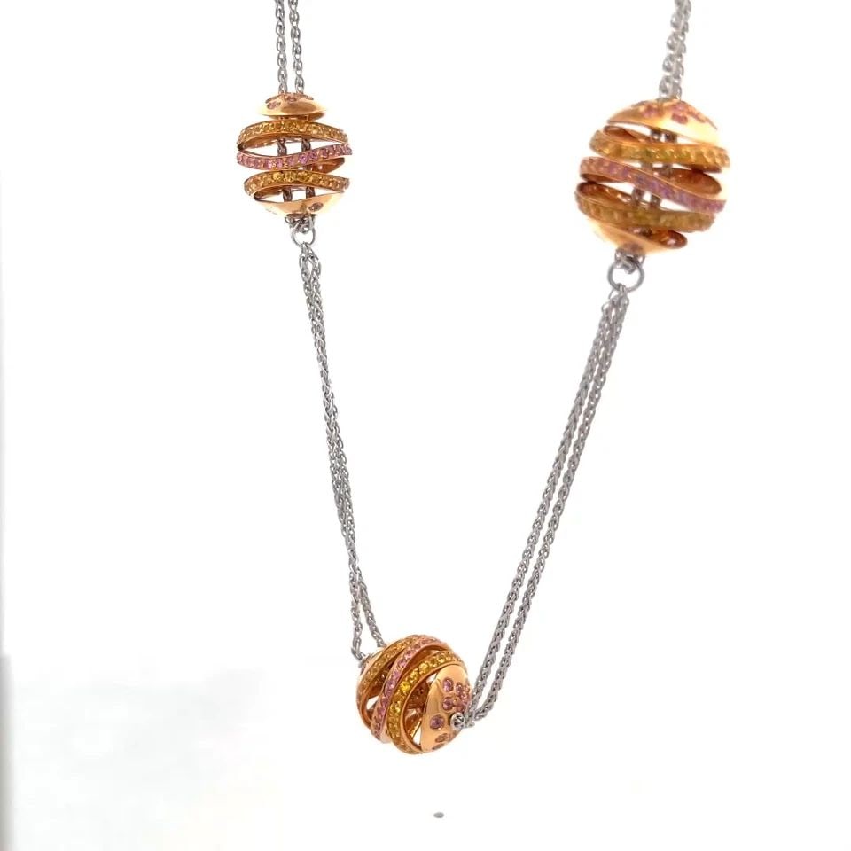6730 SAPPHIRE 18K TRI-COLOR GOLD NECKLACE MULTI-RING MOTIFS DOUBLE CHAIN: 6730 SAPPHIRE 18K TRI-COLOR GOLD NECKLACE MULTI-RING MOTIFS DOUBLE CHAIN This is a beautiful necklace, it is crafted from 18k white, rose and yellow gold. There are 5 set of triple wheel slide charms 