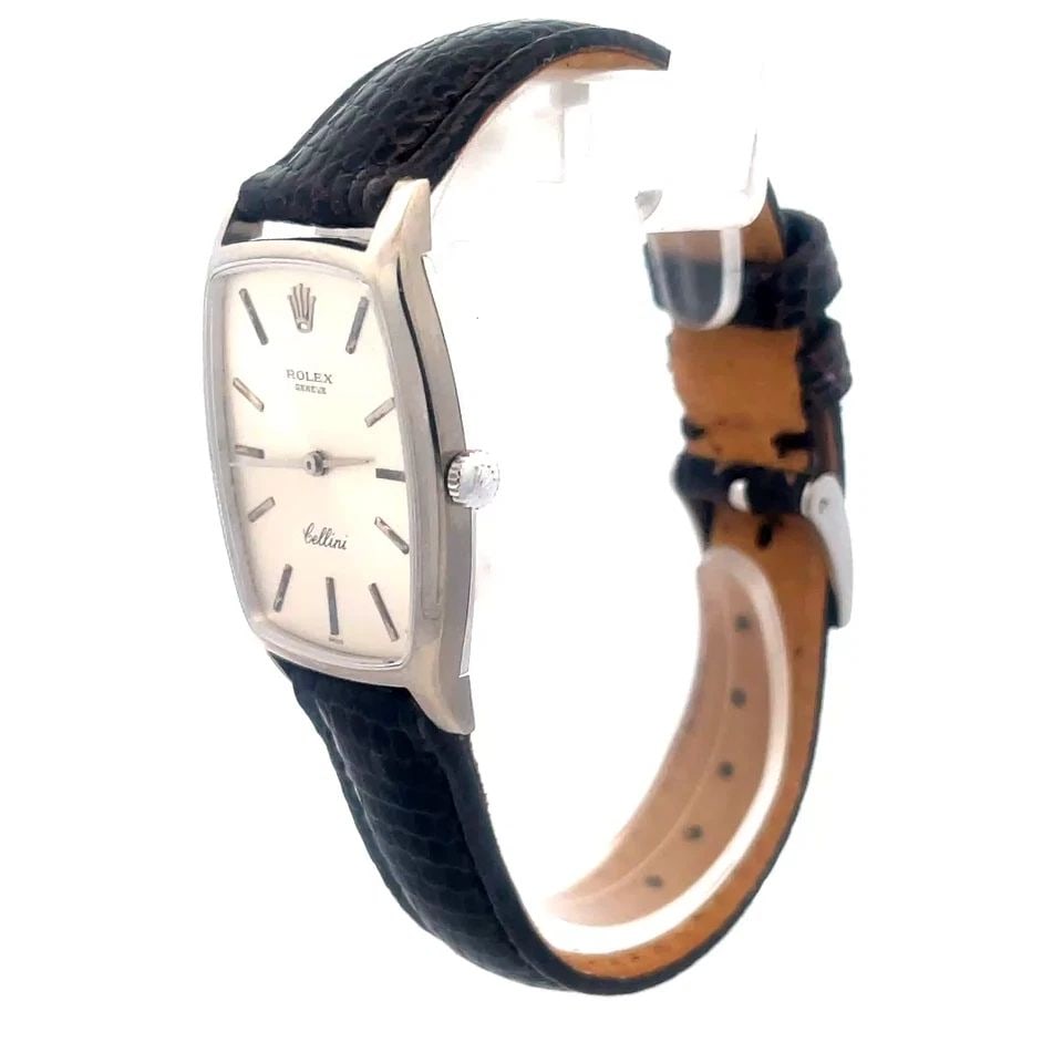 ROLEX CELLINI WRISTWATCH VINTAGE 18K WHITE GOLD MANUAL WIND LEATHER BAND: ROLEX CELLINI WRISTWATCH VINTAGE 18K WHITE GOLD MANUAL WIND LEATHER BAND The product is a vintage Rolex Cellini wristwatch made of 18k white gold case with a manual winding movement. It features a two