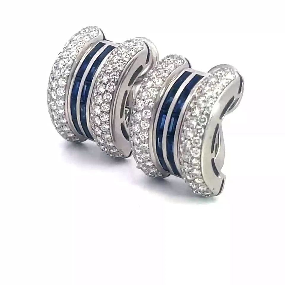 CHOPARD DIAMOND SAPPHIRE GOLD EARRINGS 18K WHITE CURVED HUGGIE STYLE: CHOPARD DIAMOND SAPPHIRE GOLD EARRINGS 18K WHITE CURVED HUGGIE STYLE These gorgeous eye-catching earrings are by Chopard featuring a curved wide bar shape with a pavé set diamond on each end and the 