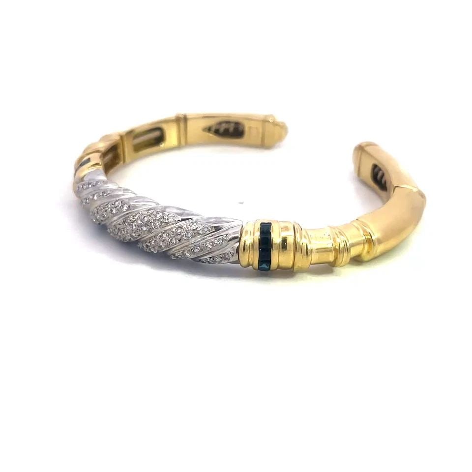 DIAMOND SAPPHIRE GOLD BRACELET 18K TWO TONE LARGE CUFF STYLE: DIAMOND SAPPHIRE GOLD BRACELET 18K TWO TONE LARGE CUFF STYLE This is a large unisex gold and diamond cuff bracelet, it is a stunning piece of fine jewelry with white gold on the front featuring a twis